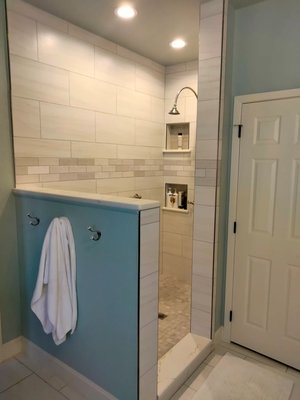 Custom walk-in shower with subway tile and built-in niches in Sherman TX bathroom remodel